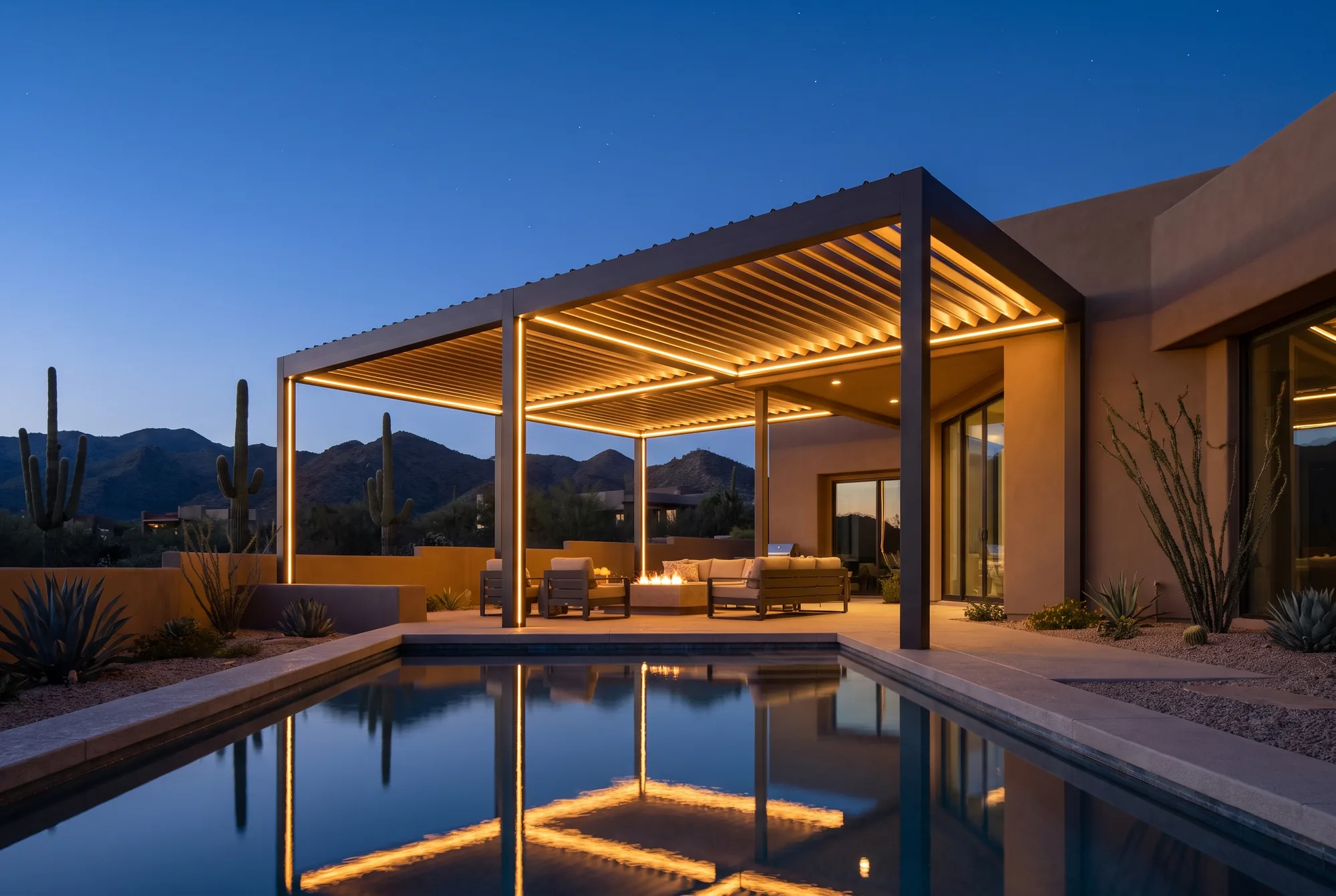 Modern louvered aluminum pergola over a desert-modern patio at dusk in Tucson